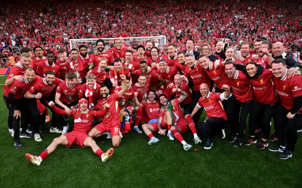 Celebration of Liverpool F.C. players and fans, showcasing a joyful moment on the pitch amidst a sea of red, perfect for a Premier League soccer-themed 4K Ultra HD desktop wallpaper.