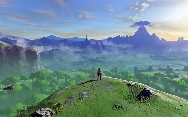 HD PC desktop wallpaper of The Legend of Zelda: Breath of the Wild — Link on a grassy hill overlooking vast Hyrule plains, with a distant volcano and castle at sunrise.