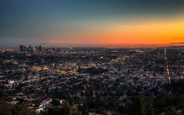 HD desktop wallpaper showcasing the Los Angeles cityscape at sunset, capturing the sprawling urban landscape and vibrant sky in the USA.
