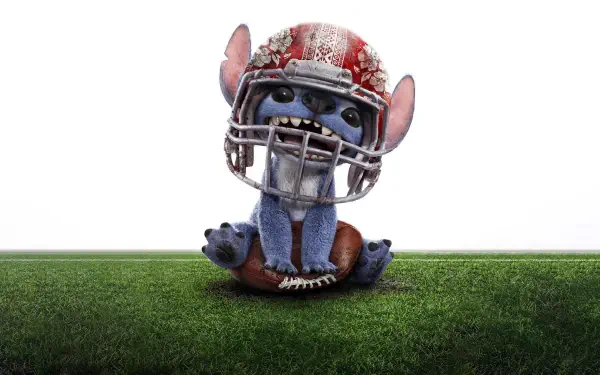 Stitch from the movie Lilo & Stitch (2025) dressed in football gear, sitting on a grassy field, shown in 4K Ultra HD PC desktop wallpaper quality.