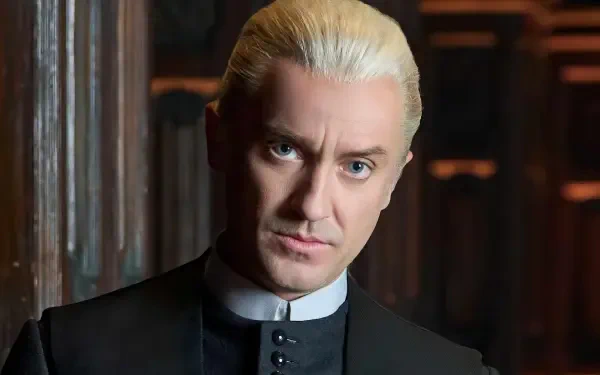 HD movie wallpaper of Draco Malfoy, portrayed by Tom Felton in the Harry Potter series, featuring his iconic platinum blonde hair and intense gaze.