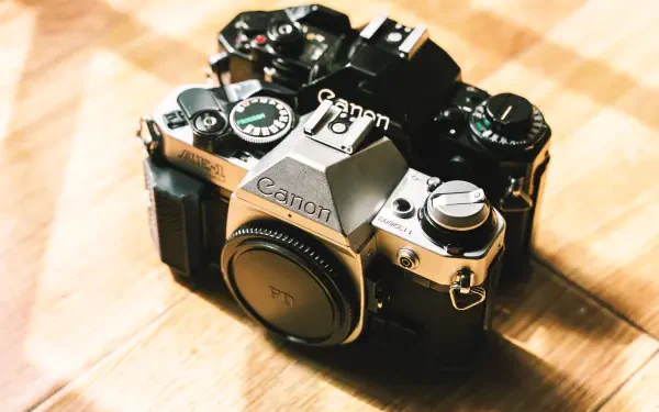 A vintage Canon camera captured in detailed photography, presented as a 4K Ultra HD PC desktop wallpaper and background.