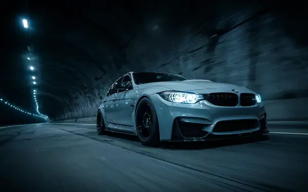 HD PC desktop wallpaper: silver BMW M3 speeding through a lit tunnel at night.