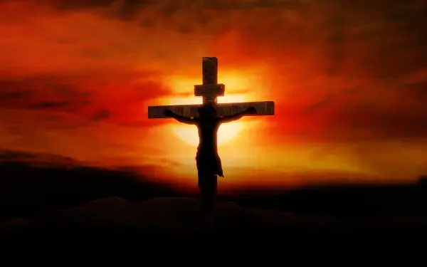 HD PC desktop wallpaper showing Jesus on the cross silhouetted against a fiery orange-red sunset — a Bible crucifixion religious scene.