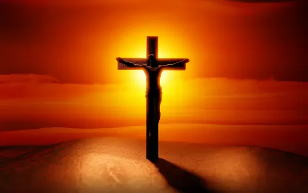 HD desktop wallpaper of Jesus on the cross silhouetted against a fiery sunset, a Bible-inspired religious crucifixion scene.