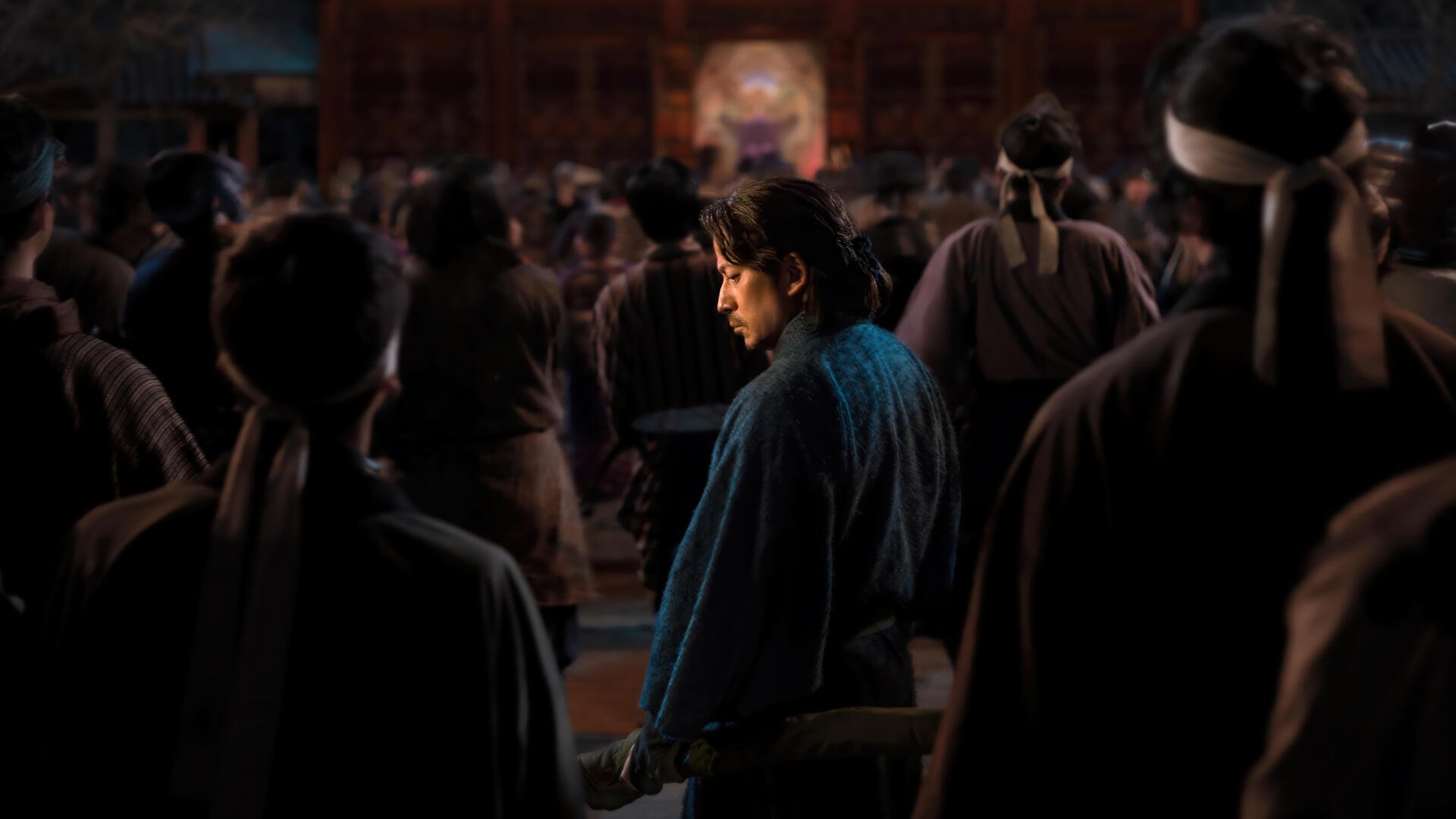 TV show Last Samurai Standing still: lone samurai in blue robe turns amid a shadowed, crowded hall, dramatic cinematic lighting — 4K Ultra HD PC desktop wallpaper/background.