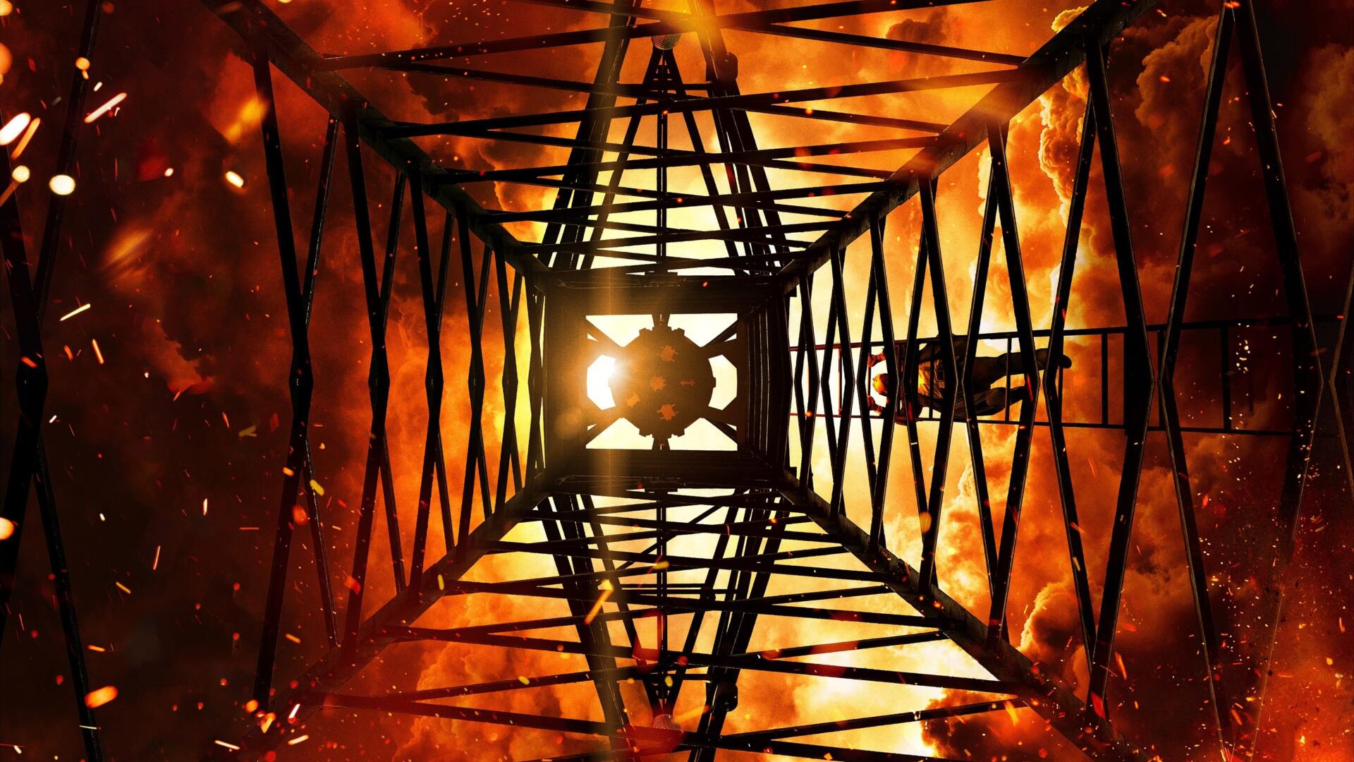 Oppenheimer 4K Ultra HD PC desktop wallpaper showing a steel tower framework seen from below against a fiery orange explosion, with flying sparks and glowing embers.