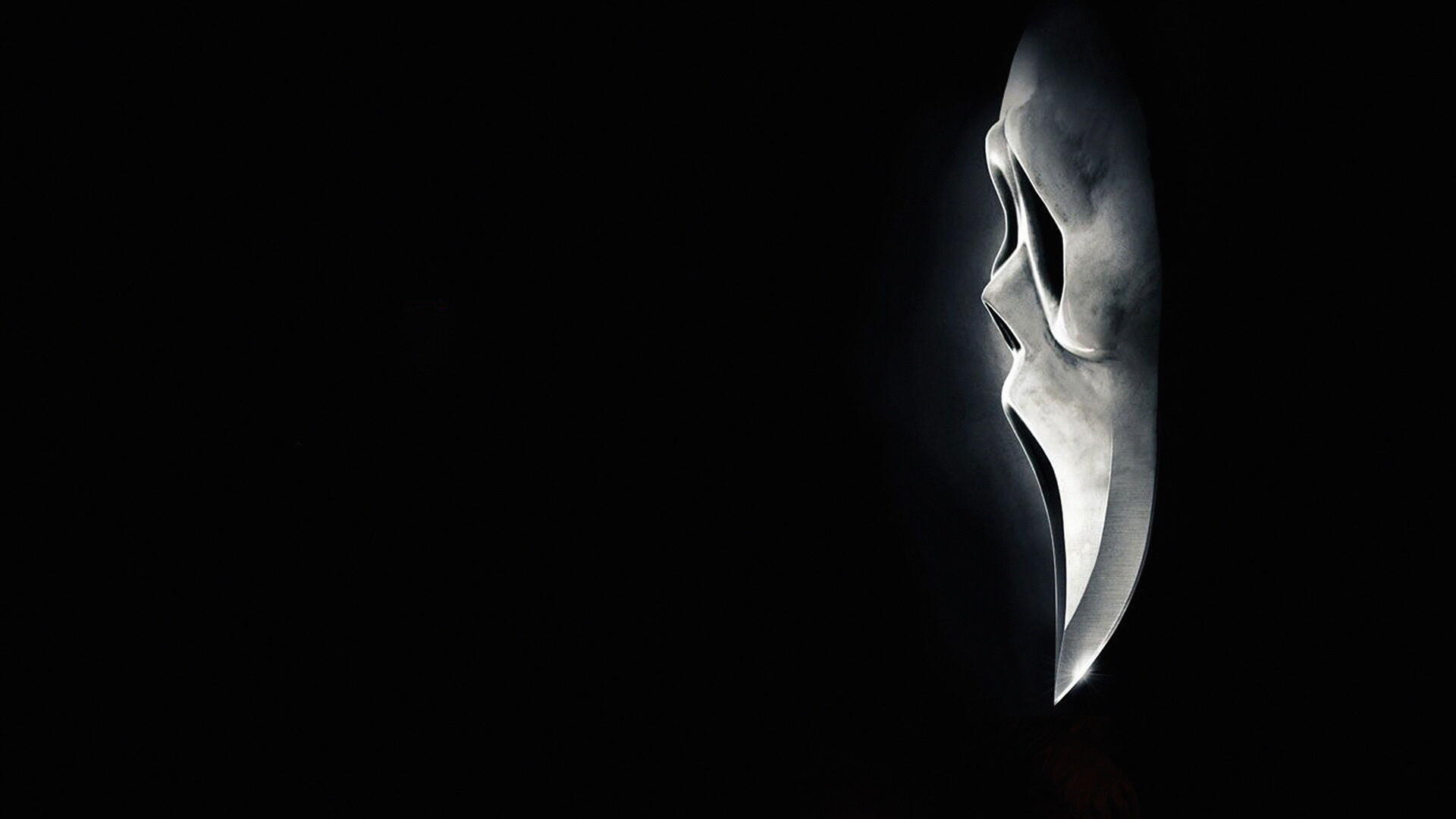 Profile of the Ghostface mask from Scream 4, illuminated against a black void with high-contrast detail — 4K Ultra HD PC desktop wallpaper and background.