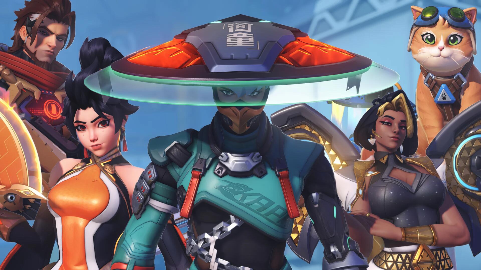 2K Quad HD PC desktop wallpaper of Overwatch FPS roster with Emre (Overwatch) front and center in a tech hat, surrounded by fellow heroes and a small cat companion.