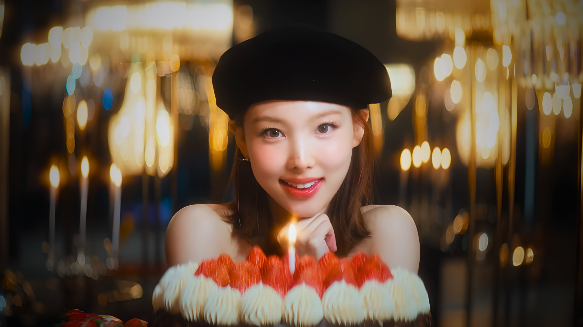 Smiling woman in a beret, K-pop idol–style model presenting a lit birthday cake with candles against warm bokeh lights — 4K Ultra HD PC desktop wallpaper background.