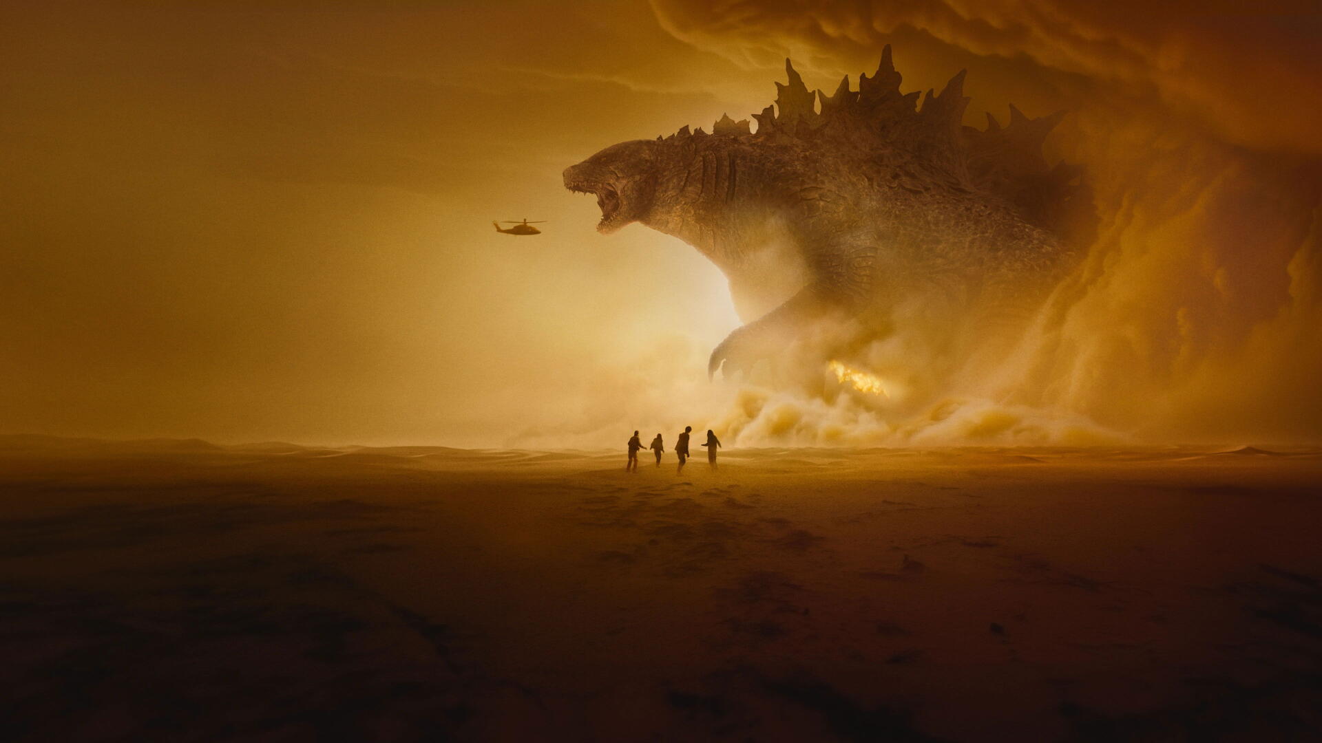 Monarch: Legacy of Monsters — 4K Ultra HD PC desktop wallpaper background: golden sandstorm with a colossal kaiju-shaped landmass looming over tiny figures and a helicopter.