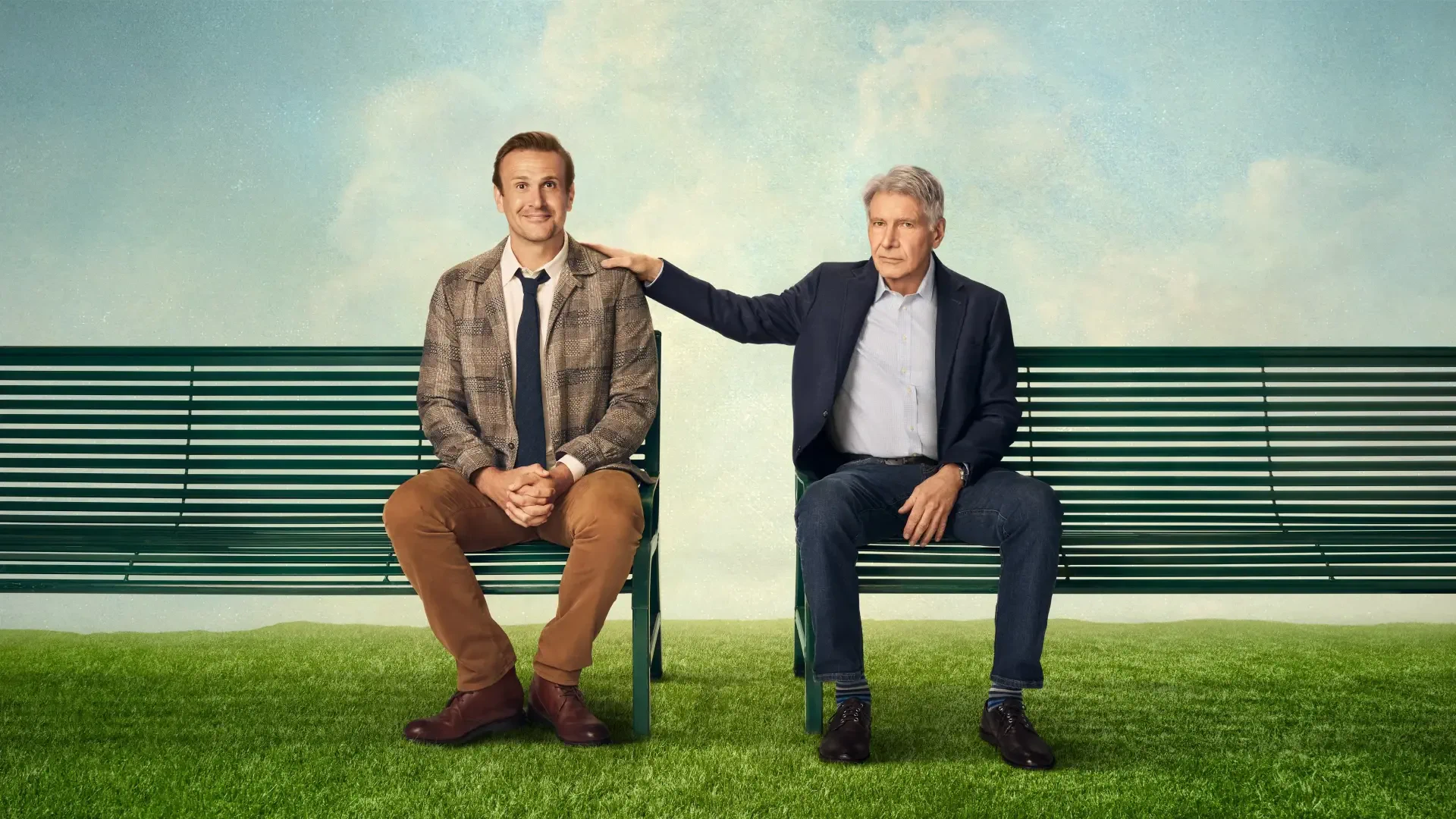 Shrinking 4K Ultra HD PC Desktop Wallpaper and Background: two men sit on a park bench on green grass beneath a blue sky, an older man gently rests his hand on the younger man's shoulder.