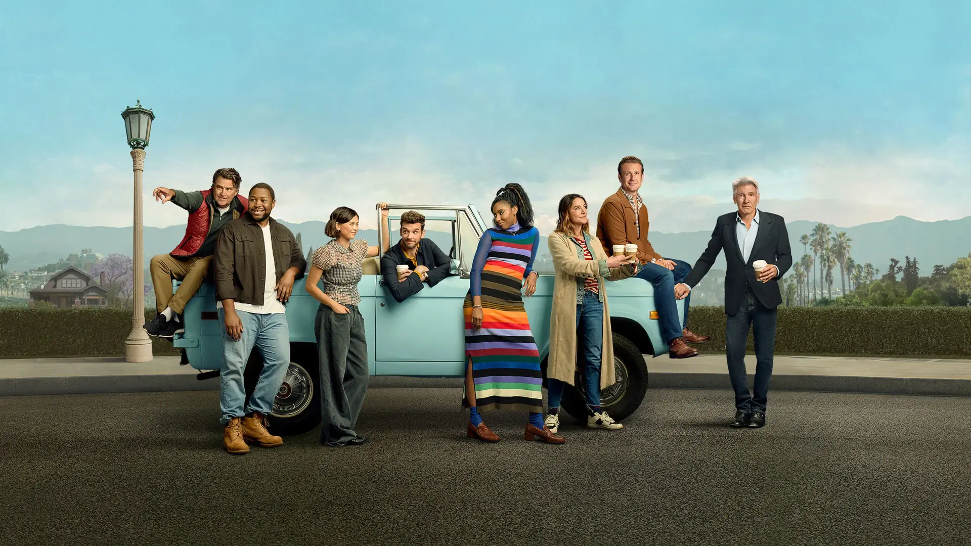 Shrinking — group of people gathered around a light-blue pickup truck on a roadside with a lamppost and distant mountains; 4K Ultra HD PC desktop wallpaper and background.