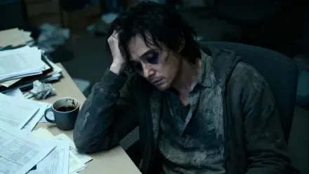 Burnt out person slumped at a cluttered desk with cold coffee and scattered papers — moody, cinematic 4K Ultra HD PC desktop wallpaper and background.