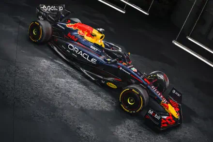 Red Bull RB21 F1 race car angled on a dark textured floor, vivid livery and Oracle branding — 2K Quad HD PC desktop wallpaper background.