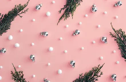 HD PC desktop wallpaper and background: pink girly Christmas scene with scattered silver baubles, tiny white snow dots and evergreen sprigs in a minimalist pink aesthetic.