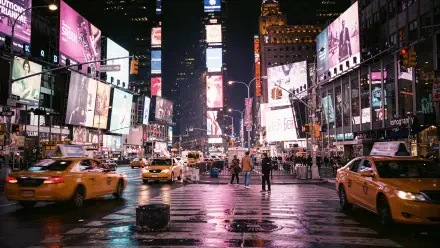 Times Square at night — 4K Ultra HD PC desktop wallpaper and background showing wet streets reflecting neon billboards, bustling pedestrians and yellow taxis in motion