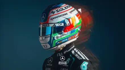 2K Quad HD PC desktop wallpaper: Mercedes AMG F1 driver wearing a colorful F1 helmet and team racing suit against a dark backdrop.