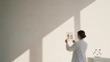 4K Ultra HD desktop wallpaper of a geneticist in a lab coat examining a DNA microarray against a sunlit white wall, a molecular model resting on a nearby table.