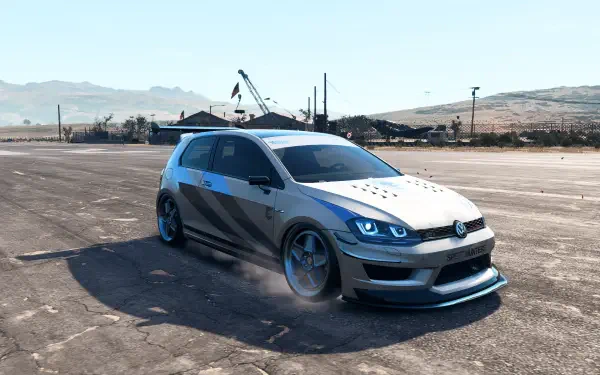 HD PC desktop wallpaper/background — Need for Speed Heat Volkswagen hatchback with widebody kit and glowing headlights drifting on an empty tarmac under a clear sky.