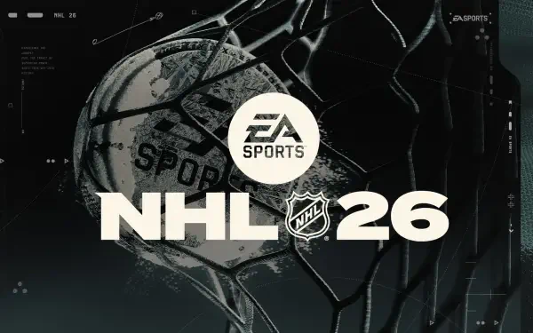 HD PC desktop wallpaper for the video game NHL 26: EA SPORTS emblem over a textured hockey puck caught in netting, bold NHL 26 title.