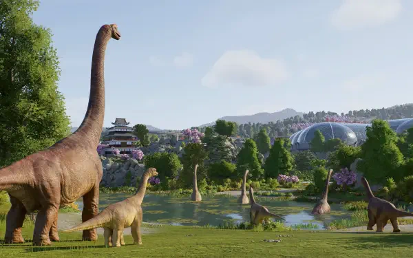 HD PC desktop wallpaper from the video game Jurassic World Evolution 3 showing a herd of brachiosaurus grazing by a lake with park domes, trees and distant mountains under a blue sky.