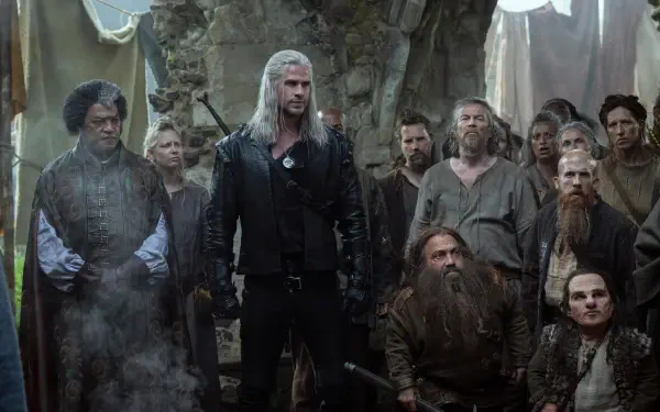 Geralt of Rivia stands center in leather armor, white hair and sword, surrounded by villagers in a ruined hall — 8K Ultra HD TV show The Witcher PC desktop wallpaper/background.