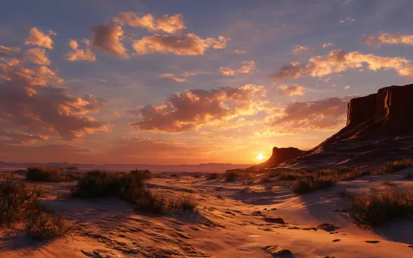 4K Ultra HD PC desktop wallpaper and background — desert sunset with sun dipping behind a mesa, warm orange clouds, rippled sand and sparse shrubs casting long shadows.