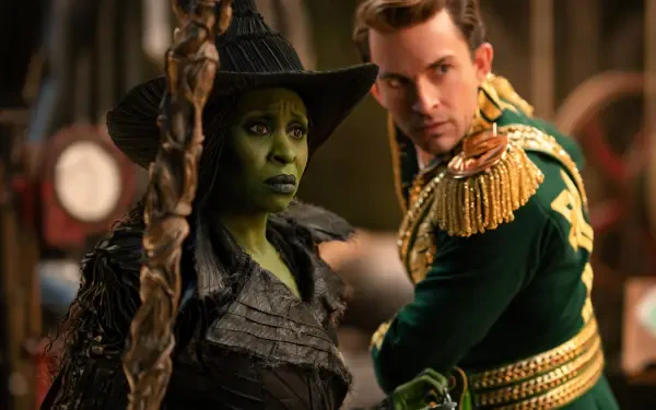 4K Ultra HD PC wallpaper of Elphaba from Wicked: For Good — green-skinned witch in a pointed hat and dark gown, flanked by a man in an ornate green-and-gold uniform.