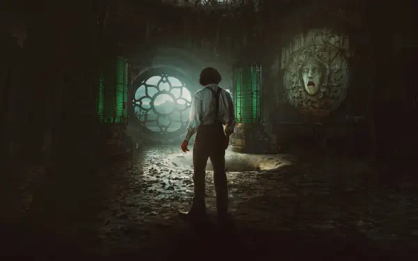 Frankenstein (2025) 4K Ultra HD PC desktop wallpaper: lone figure in a ruined, dim lab illuminated by a glowing circular window and an ominous carved stone face.