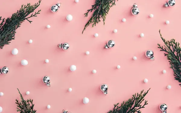HD PC desktop wallpaper and background: pink girly Christmas scene with scattered silver baubles, tiny white snow dots and evergreen sprigs in a minimalist pink aesthetic.