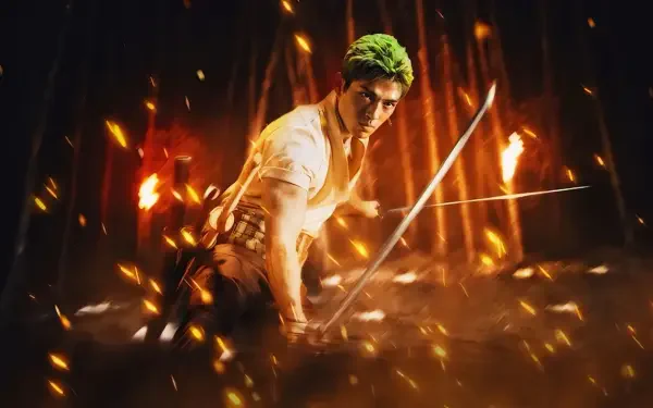 One Piece (Live Action) 2K Quad HD PC desktop wallpaper: green‑haired swordsman crouches with drawn blades amid flying sparks and roaring flames.
