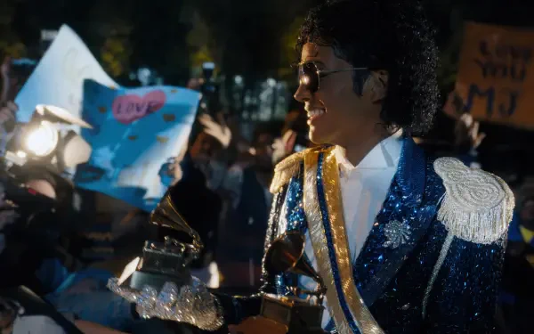 4K Ultra HD PC desktop wallpaper: scene from the movie Michael (2026) — performer in a glittering blue military-style jacket signing autographs amid cheering fans.