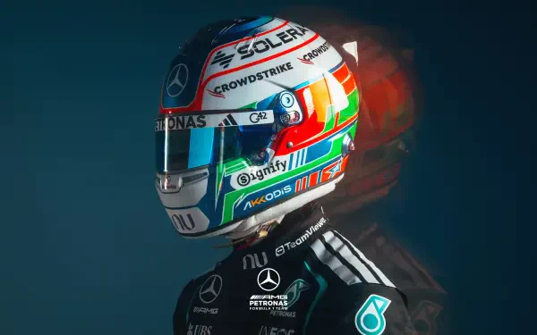 2K Quad HD PC desktop wallpaper: Mercedes AMG F1 driver wearing a colorful F1 helmet and team racing suit against a dark backdrop.