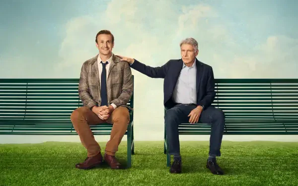 Shrinking 4K Ultra HD PC Desktop Wallpaper and Background: two men sit on a park bench on green grass beneath a blue sky, an older man gently rests his hand on the younger man's shoulder.