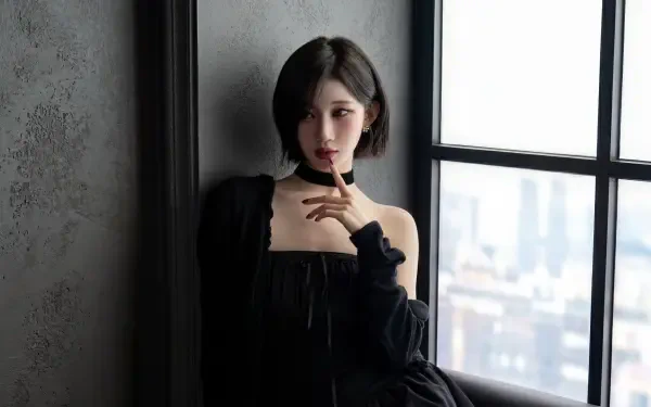 Short-haired woman in a black off-shoulder dress by a window, K-pop–inspired model styling in moody soft light — 5K Ultra HD desktop wallpaper.