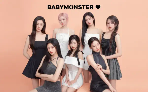 BABYMONSTER K-pop: seven members pose in black and white outfits on a peach backdrop — 5K Ultra HD PC desktop wallpaper and background.
