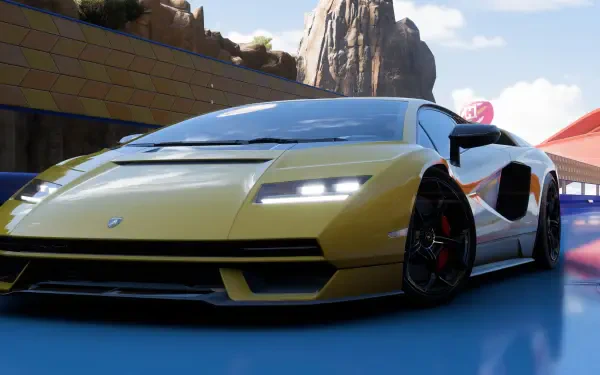 4K Ultra HD PC desktop wallpaper background from the video game Forza Horizon 5: yellow Lamborghini Countach, low-angle close-up on a sunlit track with glossy finish and motion blur.