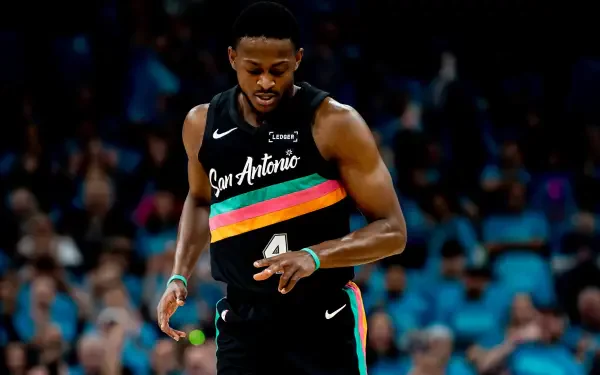 NBA basketball player in San Antonio Spurs black rainbow jersey dribbling down the court — bold 2K Quad HD PC desktop wallpaper/background.