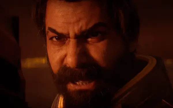 Close-up of bearded, enraged video game character Saros in warm orange light — dramatic 4K Ultra HD PC desktop wallpaper and background.