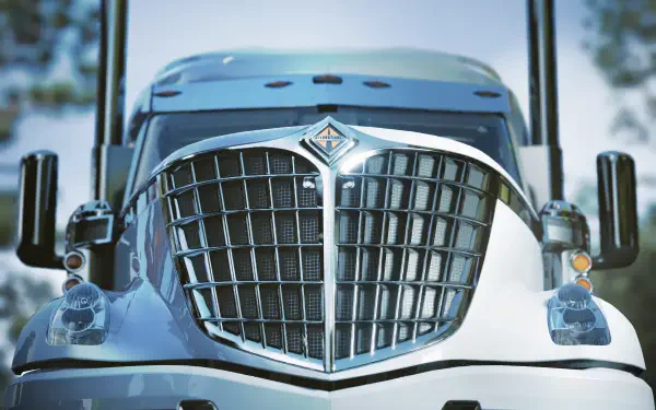 Close-up of a chrome truck grille and emblem from the video game Road Kings — 4K Ultra HD PC desktop wallpaper and background.