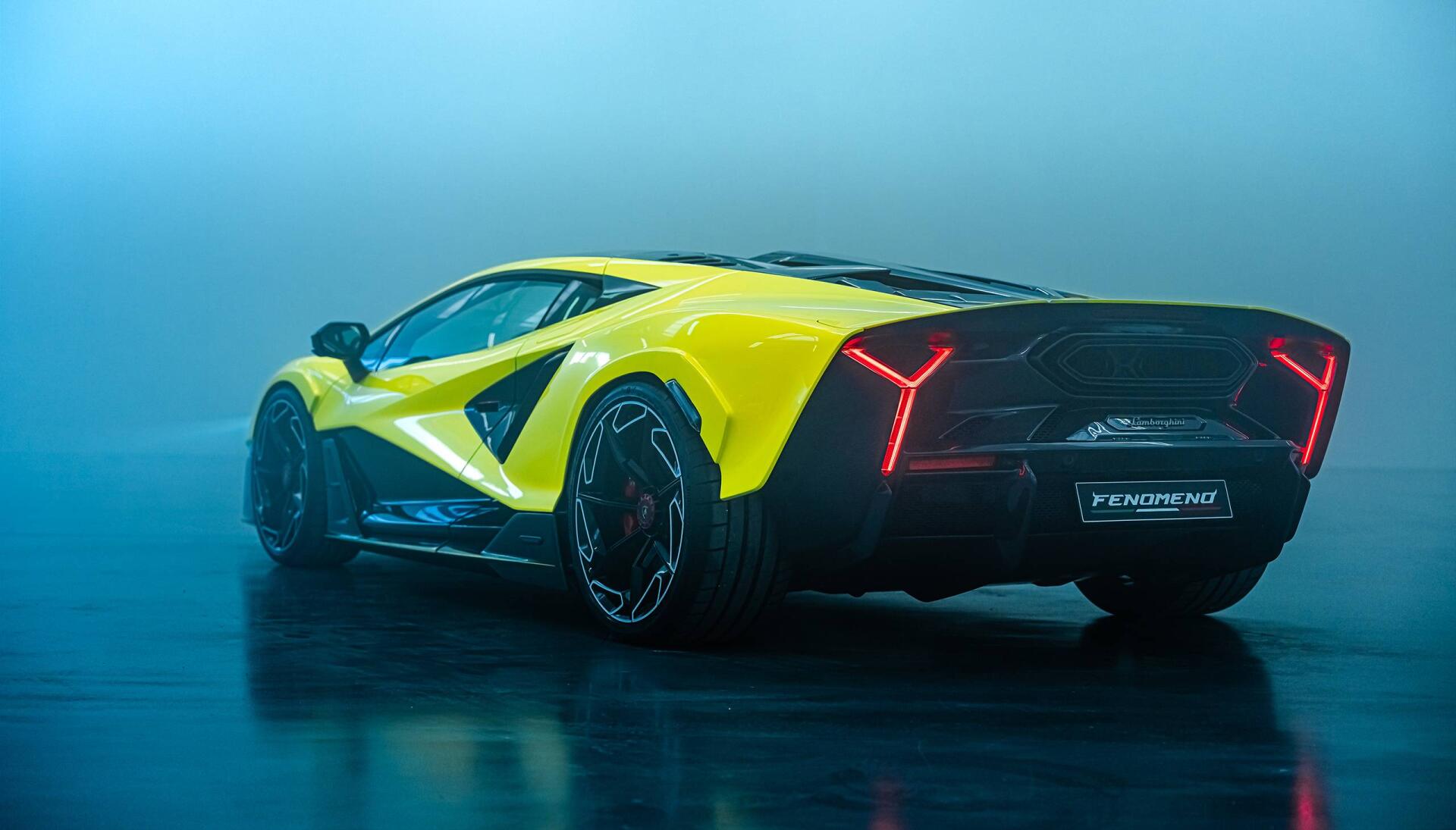 Yellow Lamborghini Fenomeno on a reflective wet floor with blue haze, rear three-quarter view — 2K Quad HD PC desktop wallpaper/background.