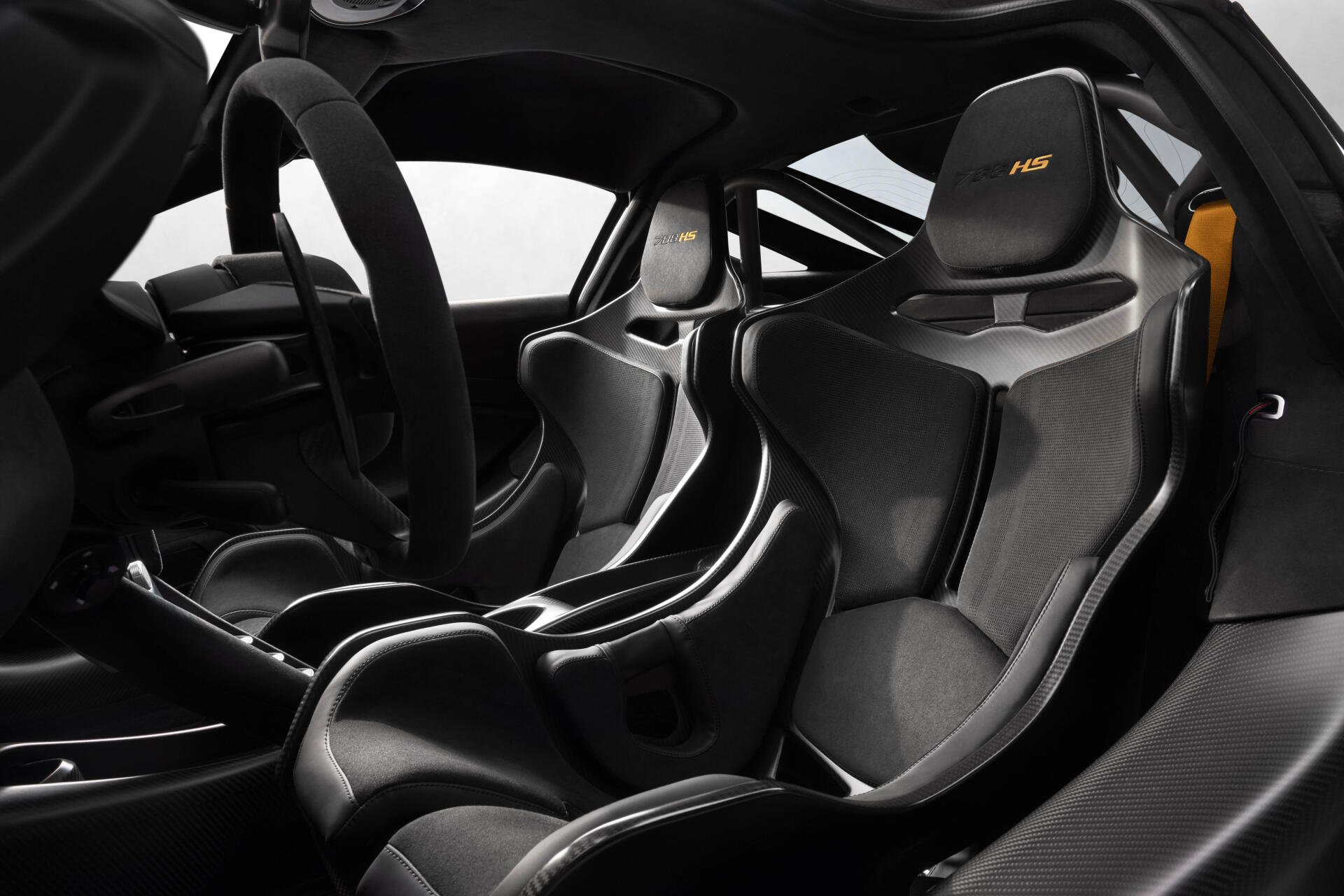 8K Ultra HD PC wallpaper of McLaren 788HS cockpit: carbon-fiber racing seats, sculpted center console and racing steering wheel in matte black and grey.