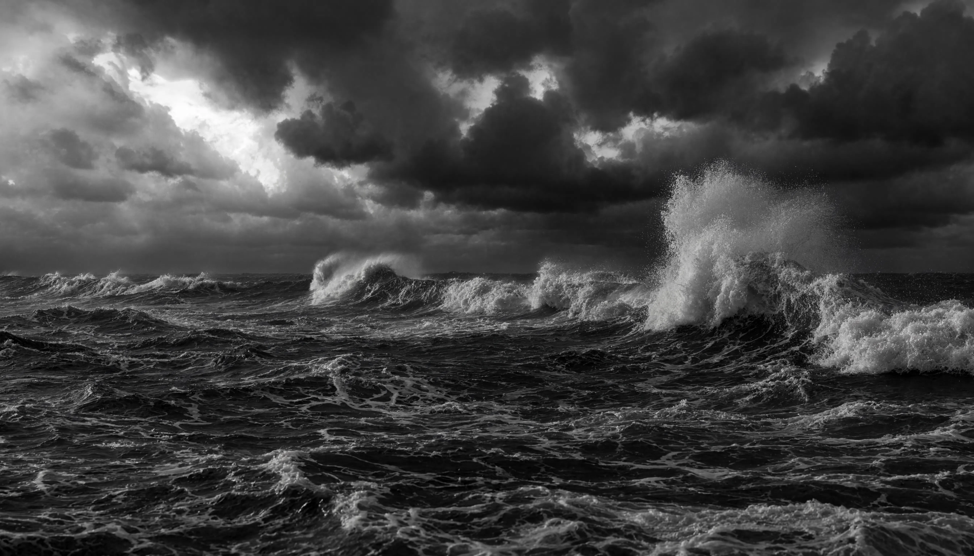 5K Ultra HD PC desktop wallpaper: stormy sea in monochrome — towering breakers, churning dark water and dramatic, brooding clouds, spray and motion under a tempestuous sky.