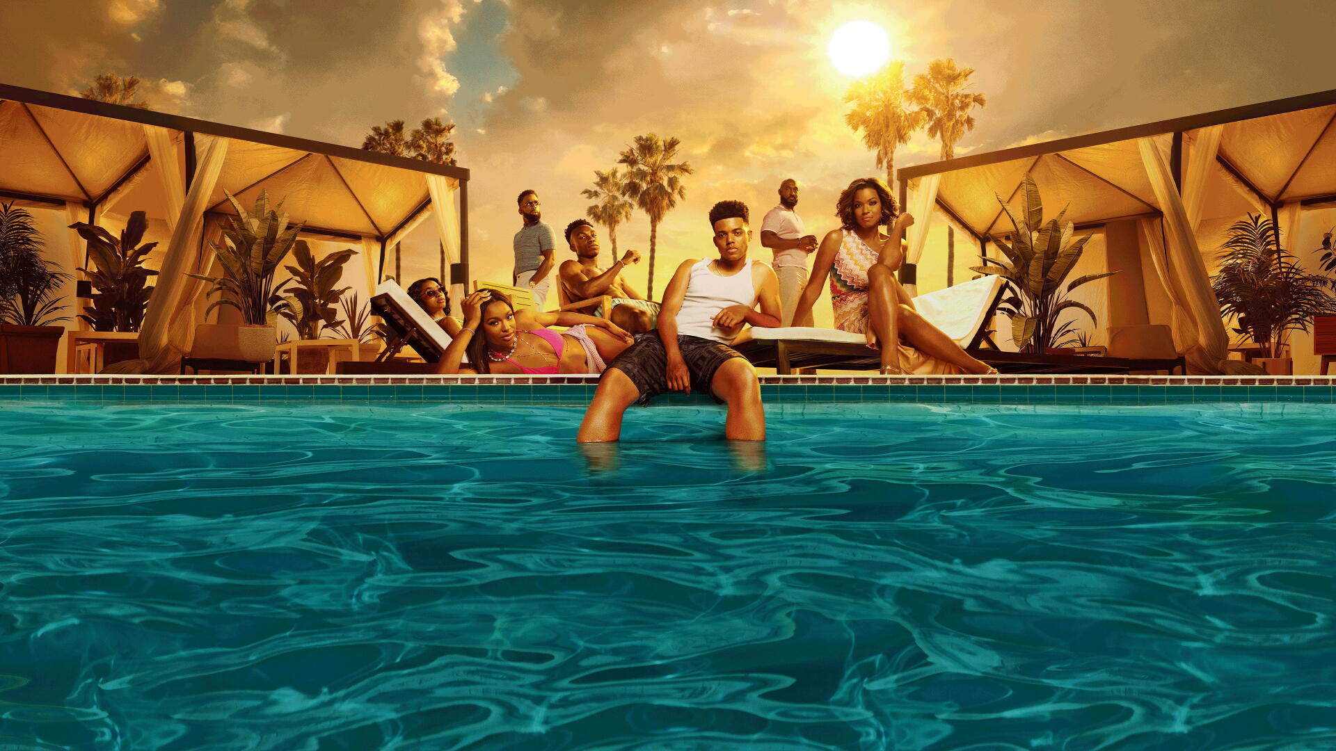 Bel-Air 4K Ultra HD PC desktop wallpaper: a group relaxing by a sunlit pool at sunset, palm trees and cabanas framing vivid teal water and a golden sky.