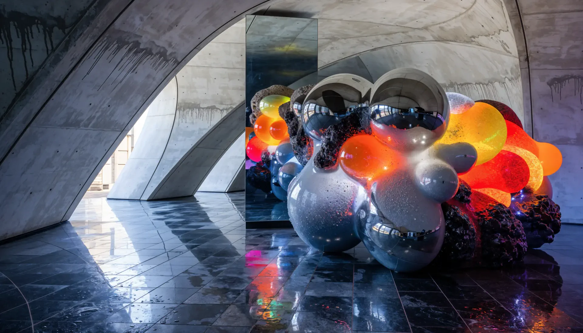 4K Ultra HD PC desktop wallpaper/background: modern sculpture installation — reflective chrome and colorful orb clusters beneath concrete arches, glossy floor reflections