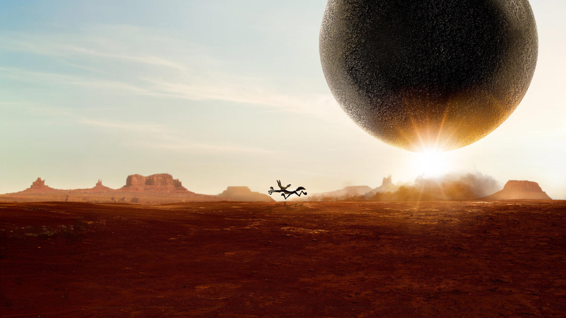 Coyote vs Acme 4K Ultra HD PC desktop wallpaper: silhouetted coyote runs across a red desert as a colossal Acme sphere looms above the sunrise horizon.