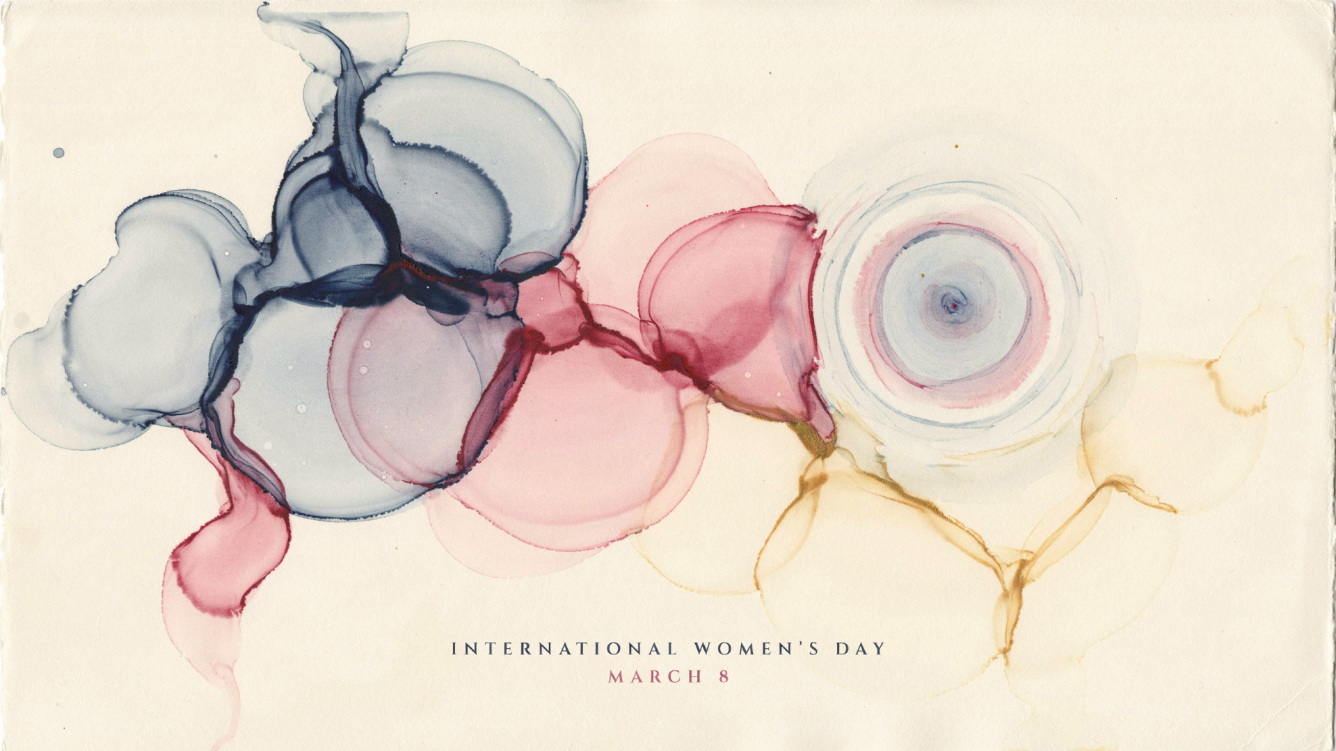 Abstract watercolor circles in soft pink, blue and gold with International Women's Day — March 8 text, styled as a 2K Quad HD PC desktop wallpaper background.