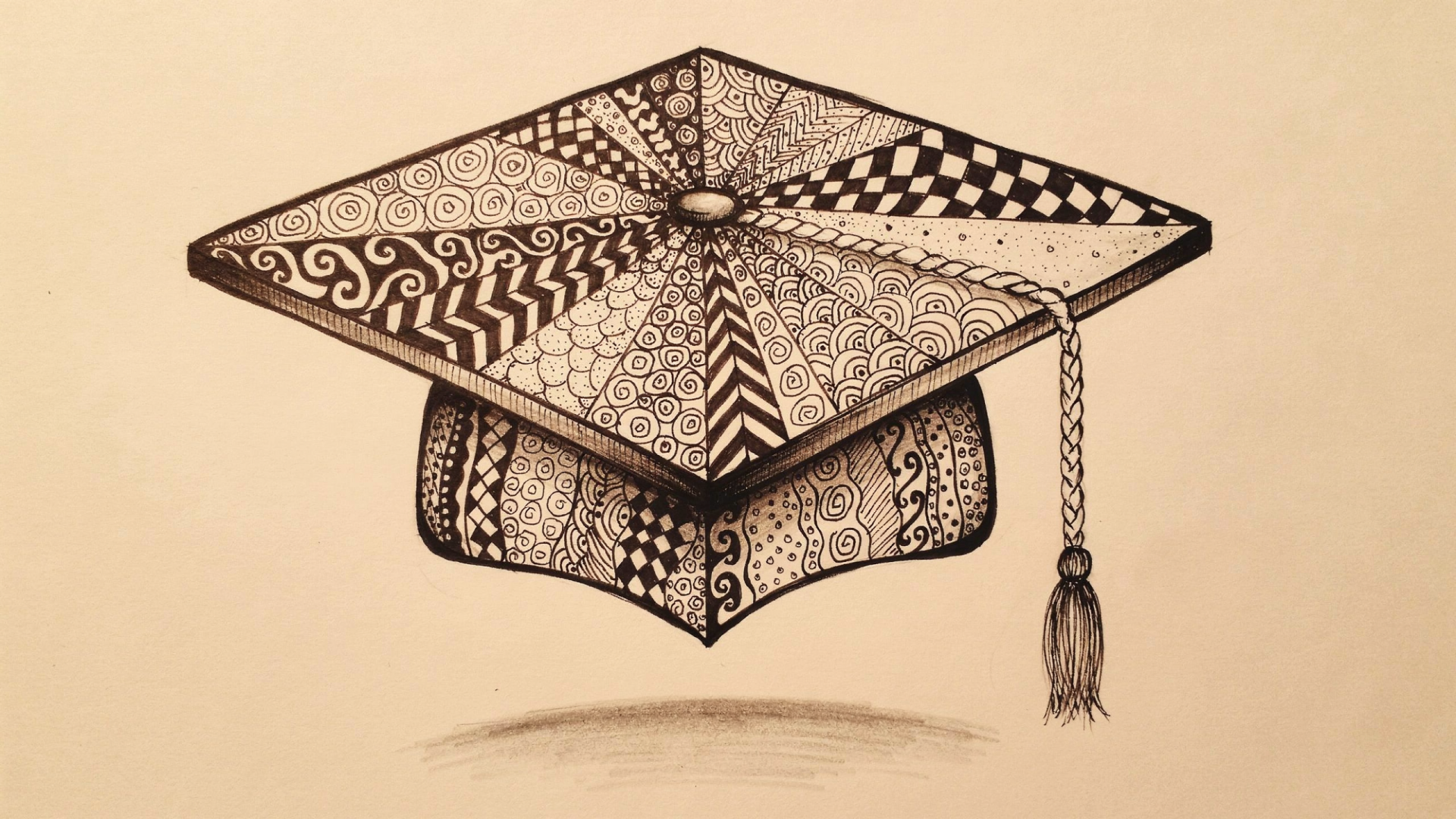 Hand-drawn graduation cap (mortarboard) with intricate black-ink patterns and tassel on a sepia backdrop — 2K Quad HD PC desktop wallpaper/background.