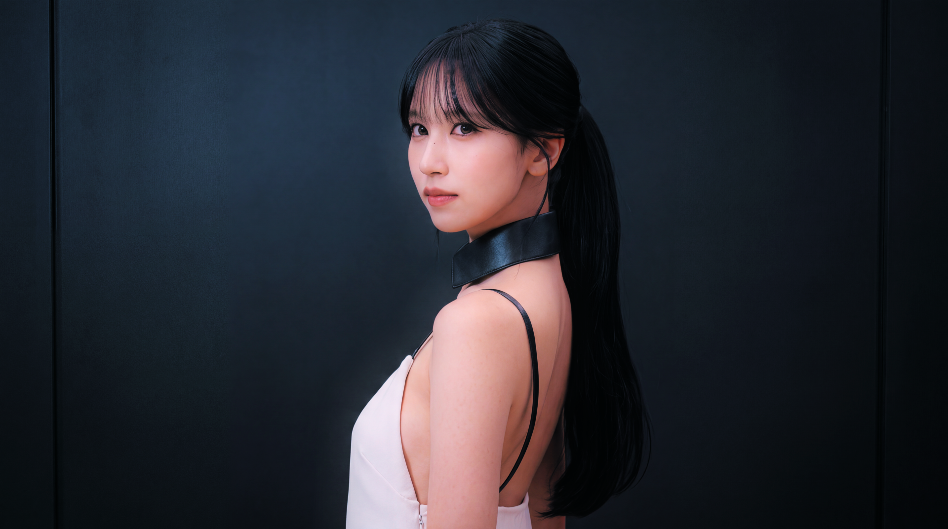Close-up portrait of a woman with a long black ponytail in a white sleeveless top and black choker, posed against a dark backdrop — 5K PC desktop wallpaper.